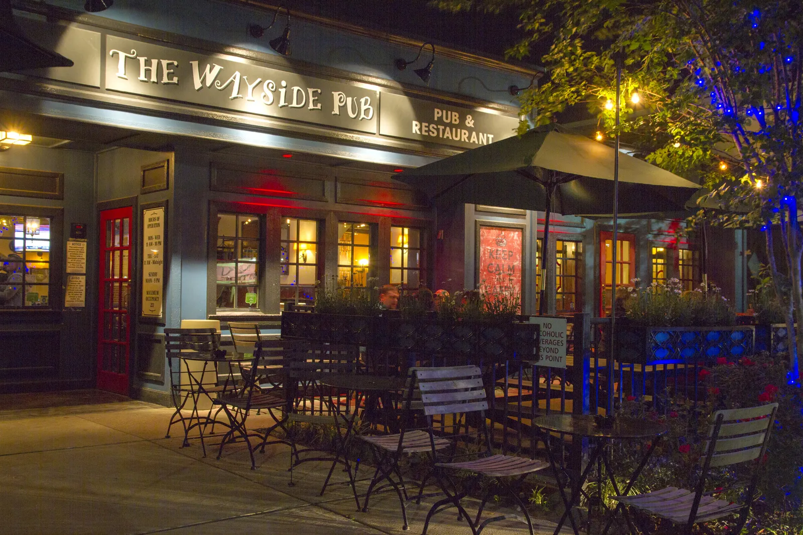 The Wayside Pub’s real illuminated facade and outdoor patio at night